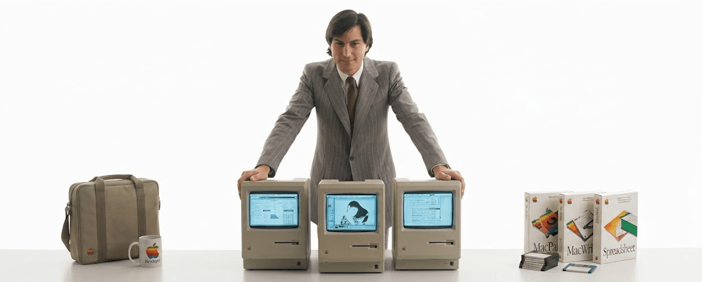 Steve Jobs with three original Apple Macintosh computers and accessories, 1984